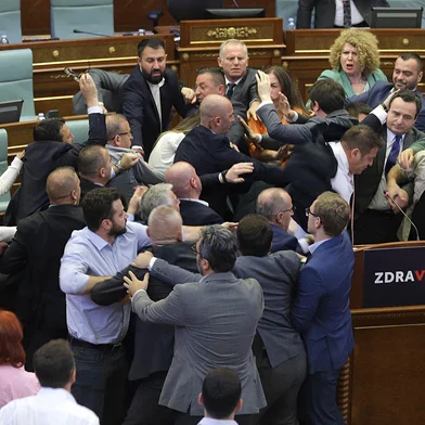 Kosovo opposition lawmakers clash with ruling members in the Kosovo parliament on July 13, 2023 during a heated debate over measures aimed at defusing tensions in restive Serb enclaves in the north. The melee kicked off as Prime Minister Albin Kurti addressed the house and was doused with water by a rival lawmaker. (Photo by AFP)<!-- NICAID(15483179) -->