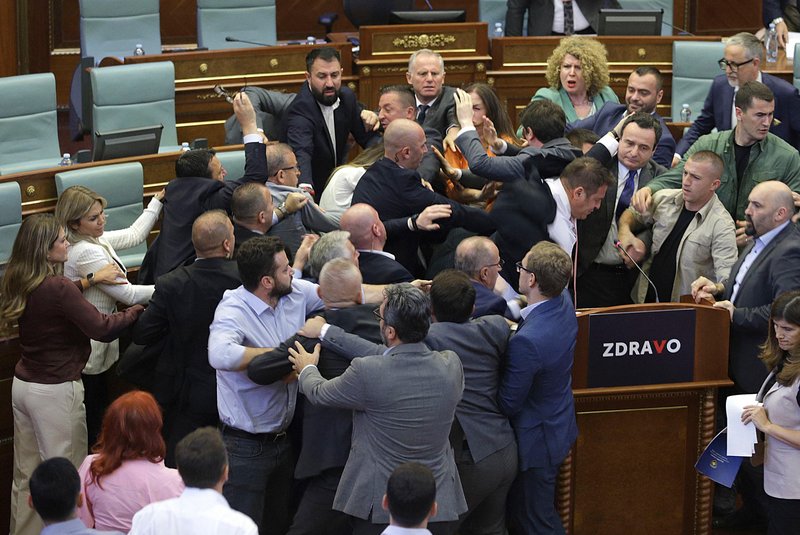 Kosovo opposition lawmakers clash with ruling members in the Kosovo parliament on July 13, 2023 during a heated debate over measures aimed at defusing tensions in restive Serb enclaves in the north. The melee kicked off as Prime Minister Albin Kurti addressed the house and was doused with water by a rival lawmaker. (Photo by AFP)<!-- NICAID(15483179) -->