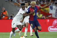 Real Madrid's Brazilian forward #07 Vinicius Junior and Barcelona's Spanish forward #19 Lamine Yamal fight for the ball during their Spanish Cup, Copa del Rey (King's Cup) final football match between FC Barcelona and Real Madrid CF at La Cartuja stadium in Seville on April 26, 2025. (Photo by Pierre-Philippe MARCOU / AFP)<!-- NICAID(16032187) -->
