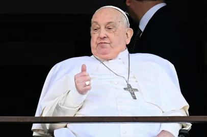 Pope Francis appears at a window of the Gemelli hospital before being discharged following a five weeks hospitalization for pneumonia, in Rome on March 23, 2025. Pope Francis is to leave hospital todayand return to his residence in the Vatican, where he is to spend "at least two months" recovering, one of his doctors announced during a press conference on March 22, 2025. (Photo by Filippo MONTEFORTE / AFP)<!-- NICAID(16004457) -->
