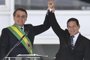 Brazil's new President Jair Bolsonaro (L), and Brazil's new Vice-President Hamilton Mourao wave to supporters during their inauguration ceremony at Planalto Palace in Brasilia on January 1, 2019. - Bolsonaro takes office with promises to radically change the path taken by Latin America's biggest country by trashing decades of centre-left policies. (Photo by EVARISTO SA / AFP)Editoria: POLLocal: BrasíliaIndexador: EVARISTO SASecao: governmentFonte: AFPFotógrafo: STF<!-- NICAID(13897160) -->