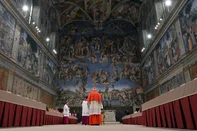 This handout picture released by the Press office shows cardinals queuing in the Sistine Chapel to swear on the Bible to never reveal the secrets of their deliberations before the start of the conclave at the Vatican on March 12, 2013. Cardinals moved into the Vatican today as the suspense mounted ahead of a secret papal election with no clear frontrunner to steer the Catholic world through troubled waters after Benedict XVI's historic resignation. The 115 cardinal electors who pick the next leader of 1.2 billion Catholics in a conclave in the Sistine Chapel will live inside the Vatican walls completely cut off from the outside world until they have made their choice. AFP PHOTO/OSSERVATORE ROMANORESTRICTED TO EDITORIAL USE - MANDATORY CREDIT AFP PHOTO/OSSERVATORE ROMANO" (Photo by OSSERVATORE ROMANO / AFP)Editoria: RELLocal: Vatican CityIndexador: -Secao: christianityFonte: OSSERVATORE ROMANO<!-- NICAID(16021229) -->