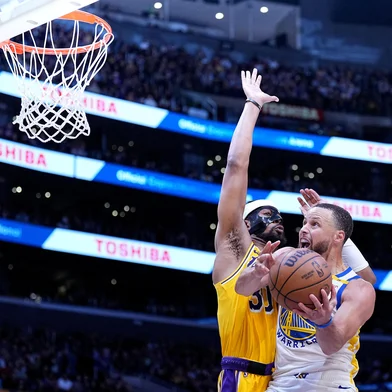 LOS ANGELES, CALIFORNIA - APRIL 03: Stephen Curry #30 of the Golden State Warriors attempts a layup against Jordan Goodwin #30 of the Los Angeles Lakers during the second half of a game at Crypto.com Arena on April 03, 2025 in Los Angeles, California. NOTE TO USER: User expressly acknowledges and agrees that, by downloading and or using this photograph, User is consenting to the terms and conditions of the Getty Images License Agreement.   Michael Owens/Getty Images/AFP (Photo by Michael Owens / GETTY IMAGES NORTH AMERICA / Getty Images via AFP)<!-- NICAID(16010062) -->