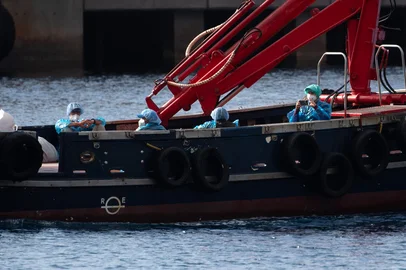 JORGE GUERRERO / AFP People wearing blue protective suits are evacuated on a boat from the Dutch flagged hantavirus-stricken cruise ship MV Hondius at the industrial port of Granadilla de Abona on the island of Tenerife in Spain's Canary Islands on May 10, 2026. Repatriation flights for the nearly 150 passengers onboard the ship hit by a deadly hantavirus outbreak are planned to the United States, Britain, France, and other countries, Spain's interior minister announced on Saturday. Most of the nearly 150 people on board will be transferred to shore on smaller vessels then by bus to the airport and then flown home after weeks at sea. (Photo by JORGE GUERRERO / AFP)<!-- NICAID(16282084) -->
