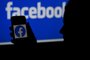 (FILES) In this file illustration photo taken on April 7, 2021, a smart phone screen displays the logo of Facebook on a Facebook website background, in Arlington, Virginia. - Facebook on June 21, 2021 began rolling out its service for people seeking audio-based connections in a direct challenge to the upstart social platform Clubhouse. The "live audio rooms" will enable users of the social media giant to listen to, and sometimes participate in, conversations led by celebrities and "influencers" or create a fundraiser on the platform. (Photo by OLIVIER DOULIERY / AFP)<!-- NICAID(14820643) -->
