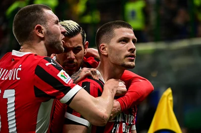 AC Milan's Serbian forward #09 Luka Jovic (R) celebrates with teammates after scoring AC Milan's first goal during the Coppa Italia second leg semi-final football match between Inter Milan and AC Milan at the San Siro stadium in Milan on April 23, 2025. (Photo by Piero CRUCIATTI / AFP)<!-- NICAID(16022929) -->