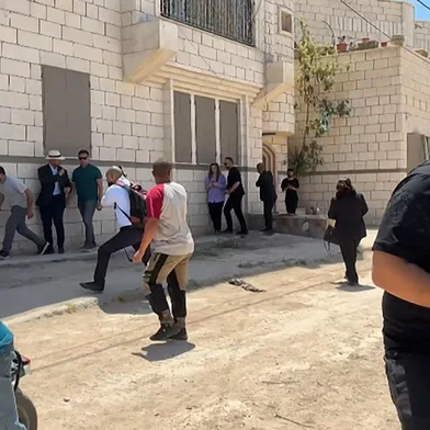 This frame grab from AFPTV footage shows members of a diplomatic delegation from the European Union reacting after shots were fired as they gathered in the eastern entrance of Jenin camp during a visit to the city of Jenin, on May 21, 2025, amid an ongoing Israeli military offensive in the occupied West Bank. The Palestinian Authority accused Israeli forces of firing on diplomats as they visited the flashpoint West Bank city of Jenin on May 21, releasing video of two soldiers aiming rifles at a group of people. (Photo by Mohammad Ateeq / AFPTV / AFP)<!-- NICAID(16042801) -->