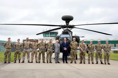Britain's King Charles III (C-L) officially hands over the role of Colonel-in-Chief of the Army Air Corps to Britain's Prince William, Prince of Wales (C-R) in front of an Apache helicopter at the Army Aviation Centre in Middle Wallop, England, on May 13, 2024. (Photo by Kin Cheung / POOL / AFP)<!-- NICAID(15762489) -->