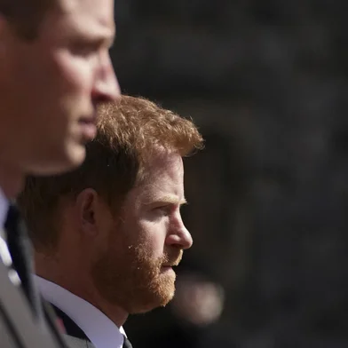 ALTERNATIVE CROP VERSION - Britain's Prince William, Duke of Cambridge, Peter Phillips and Britain's Prince Harry, Duke of Sussex walk during the funeral procession of Britain's Prince Philip, Duke of Edinburgh to St George's Chapel in Windsor Castle in Windsor, west of London, on April 17, 2021. - Philip, who was married to Queen Elizabeth II for 73 years, died on April 9 aged 99 just weeks after a month-long stay in hospital for treatment to a heart condition and an infection. (Photo by Victoria Jones / POOL / AFP) / ALTERNATIVE CROP VERSION<!-- NICAID(14761045) -->