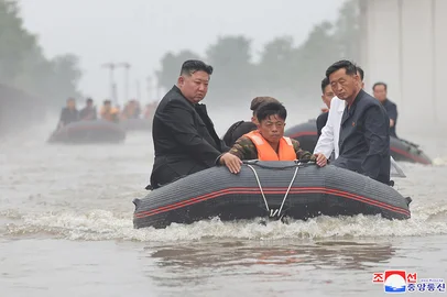 This recent undated photo released by North Korea's official Korean Central News Agency (KCNA) via KNS on July 31, 2024 shows North Korea's leader Kim Jong Un (L) riding in a dingey through flood waters as he inspects the area for damage after record-breaking heavy rains on July 29 in the city of Sinuiju in North Pyongan Province. (Photo by KCNA VIA KNS / AFP) / - South Korea OUT / REPUBLIC OF KOREA OUT   ---EDITORS NOTE--- RESTRICTED TO EDITORIAL USE - MANDATORY CREDIT "AFP PHOTO/KCNA VIA KNS" - NO MARKETING NO ADVERTISING CAMPAIGNS - DISTRIBUTED AS A SERVICE TO CLIENTSTHIS PICTURE WAS MADE AVAILABLE BY A THIRD PARTY. AFP CAN NOT INDEPENDENTLY VERIFY THE AUTHENTICITY, LOCATION, DATE AND CONTENT OF THIS IMAGE. THIS PHOTO IS DISTRIBUTED EXACTLY AS RECEIVED BY AFP. / <!-- NICAID(15831984) -->