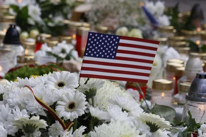 A makeshift memorial with flowers and candles for the US soldiers who died at a Pabrade training ground, outside the US Embassy in Vilnius, Lithuania, on April 1, 2025. Three of the four United States soldiers missing in Lithuania since last week were found dead on March 31, 2025, the US army said after rescuers recovered the soldiers' armoured vehicle from a swamp. (Photo by Petras Malukas / AFP)<!-- NICAID(16007912) -->