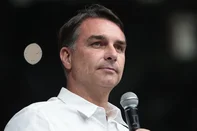 Brazilian senator and Liberal Party (PL) presidential candidate Flavio Bolsonaro speaks during the official celebration marking the 100th anniversary of the Assembly of God (Madureira Ministry) at the Maracanazinho Gymnasium in Rio de Janeiro, Brazil, on October 10, 2026. (Photo by Douglas SHINEIDR / AFP)<!-- NICAID(16385420) -->