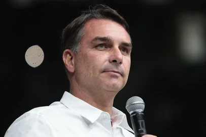 Brazilian senator and Liberal Party (PL) presidential candidate Flavio Bolsonaro speaks during the official celebration marking the 100th anniversary of the Assembly of God (Madureira Ministry) at the Maracanazinho Gymnasium in Rio de Janeiro, Brazil, on October 10, 2026. (Photo by Douglas SHINEIDR / AFP)<!-- NICAID(16385420) -->