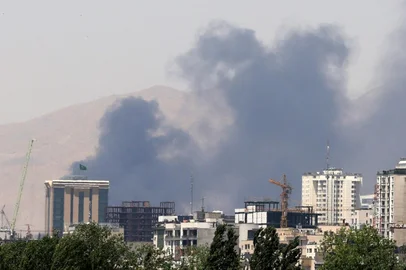 Smoke billows for the second day from the Shahran oil depot, northwest of Tehran, on June 16, 2025. Iran unleashed a barrage of missile strikes on Israeli cities early on June 16, after Israel struck military targets deep inside Iran, with both sides threatening further devastation. (Photo by ATTA KENARE / AFP)<!-- NICAID(16060314) -->