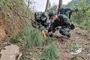 This photo taken on March 21, 2022 shows paramilitary police officers conducting a search at the site of the China Eastern Airlines plane crash in Tengxian county, Wuzhou city, in China's southern Guangxi region. - A China Eastern passenger jet carrying 132 people crashed onto a mountainside in southern China on March 21 causing a large fire, shortly after losing contact with air traffic control and dropping thousands of metres in just three minutes. (Photo by CNS / AFP) / China OUT<!-- NICAID(15047410) -->