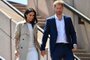 (FILES) In this file photo taken on October 16, 2018 Britain's Prince Harry and his wife Meghan walk down the stairs of Sydneys iconic Opera House to meet people in Sydney. - After a week of digs at Britain's royal family, just how far will Prince Harry and Meghan Markle go in their hotly anticipated interview with Oprah Winfrey? Millions of people will tune in to CBS the evening of March 7, 2021 to find out, and if that trickle of excerpts is any indication, they have scores to settle with Buckingham Palace a bit over a year after giving up frontline duties as royals and moving to southern California. (Photo by SAEED KHAN / AFP)<!-- NICAID(14736937) -->