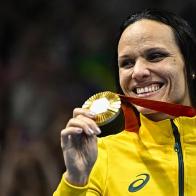 Gold medallist Brazil's Maria Carolina Gomes Santiago poses on the podium of the Women's 100m Backstroke - S12 Final swimming event during the Paris 2024 Paralympic Games at The Paris La Defence Arena, in Nanterre, west of Paris, on August 31, 2024. (Photo by JULIEN DE ROSA / AFP)<!-- NICAID(15855180) -->