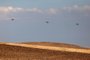 Israeli Air Force heavy lift military transport helicopters fly over in the southern Negev desert on April 14, 2024. (Photo by AHMAD GHARABLI / AFP)<!-- NICAID(15734780) -->