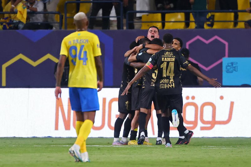 Taawoun's players celebrate their second goal during the Saudi Pro League football match between Al-Nassr and Al-Taawoun at King Saud University Stadium in Riyadh on August 18, 2023. (Photo by Fayez NURELDINE / AFP)<!-- NICAID(15514783) -->