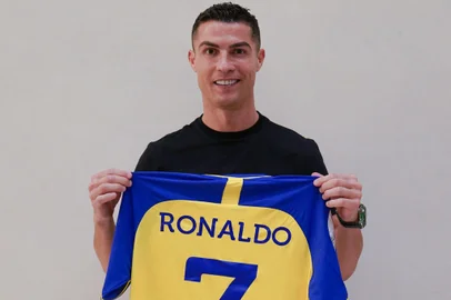 A handout picture released by Saudi Arabia's al-Nasr football club shows Portugal's forward Cristiano Ronaldo posing with the club's number seven jersey in Madrid on December 30, 2022 upon signing for the Saudi Arabian club. - Cristiano Ronaldo on December 30 signed for al-Nasr of Saudi Arabia, the club announced, in a deal believed to be worth more than 200 million euros. The 37-year-old penned a contract which will take him to June 2025. (Photo by Al Nassr Football Club / AFP) / == RESTRICTED TO EDITORIAL USE - MANDATORY CREDIT "AFP PHOTO / HO /AL NASSR FOOTBALL CLUB" - NO MARKETING NO ADVERTISING CAMPAIGNS - DISTRIBUTED AS A SERVICE TO CLIENTS ==Editoria: SPOLocal: MadridIndexador: -Secao: soccerFonte: Al Nassr Football ClubFotógrafo: STR<!-- NICAID(15309889) -->