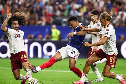 FRANCK FIFE / AFP France's forward #10 Kylian Mbappe kicks the ball past Spain's defender #24 Marc Cucurella and midfielder #05 Marcos Llorente during the 2026 World Cup football tournament semi-final match between France and Spain at the Dallas Stadium in Arlington on July 14, 2026. (Photo by FRANCK FIFE / AFP)<!-- NICAID(16327044) -->