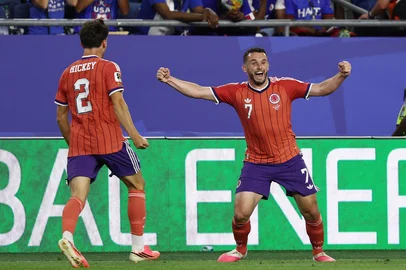 FRANCK FIFE / AFP Scotland's midfielder #07 John McGinn celebrates with teammate defender #02 Aaron Hickey after scoring his team's first goal during the 2026 World Cup Group C football match between Haiti and Scotland at the Boston Stadium in Foxborough on June 13, 2026. (Photo by FRANCK FIFE / AFP)<!-- NICAID(16305923) -->