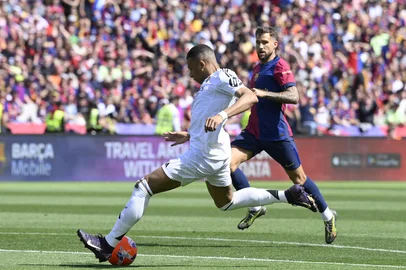 Real Madrid's French forward #09 Kylian Mbappe shoots to score their second goal during the Spanish league football match between FC Barcelona and Real Madrid CF at Estadi Olimpic Lluis Companys in Barcelona, on May 11, 2025. (Photo by Josep LAGO / AFP)<!-- NICAID(16034723) -->