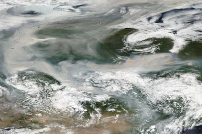 This NASA Earth Observatory image released on August 7, 2021 shows smoke emitted from hundreds of forest fires covering most of Russia on August 6, 2021. This true-color image, which was acquired by Moderate Resolution Imaging Spectroradiometer (MODIS) on board NASAs Aqua satellite on August 6, was created using data from four passes of the satellite over the region. The smoke, which was so thick that most of the land below was obscured from view, stretches about 2,000 miles (3,200 km) from east to west and 2,500 miles (4,000 km) from south to northbut it captures only a small part of the smoke from the Russian fires. This week, wildfire smoke has travelled more than 3,000 km (1,864 mi) from Yakutia to reach the North Pole (Photo by Handout / NASA Earth Observatory / AFP) / RESTRICTED TO EDITORIAL USE - MANDATORY CREDIT "AFP PHOTO / NASA  " - NO MARKETING - NO ADVERTISING CAMPAIGNS - DISTRIBUTED AS A SERVICE TO CLIENTS<!-- NICAID(14857853) -->