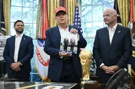 US President Donald Trump flanked by US Vice President JD Vance(L) and FIFA president Gianni Infantino (R), holds a photograph of him with Russian President Vladimir Putin in Alaska as he speaks in the Oval Office of the White House in Washington, DC, on August 22, 2025.. Trump announced the 2026 World Cup draw will be held on December 5 at Washington's Kennedy Center. (Photo by ANDREW CABALLERO-REYNOLDS / AFP)<!-- NICAID(16108750) -->