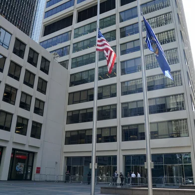 Flags fly at half-staff outside the 345 Park Avenue building, the scene of last night's deadly shootings in Midtown Manhattan in New York on July 29, 2025. A man who killed four people, then committed suicide in a New York skyscraper, may have been targeting the NFL offices there because he blamed the American football league for brain injuries he said he suffered, Mayor Eric Adams said Tuesday. The revelation that the killer, identified as 27-year-old Shane Tamura, carried a note referring to the degenerative brain disease chronic traumatic encephalopathy (CTE), offered the first possible motive for the shootings late Monday that brought central Manhattan to a standstill. (Photo by TIMOTHY A. CLARY / AFP)<!-- NICAID(16090003) -->