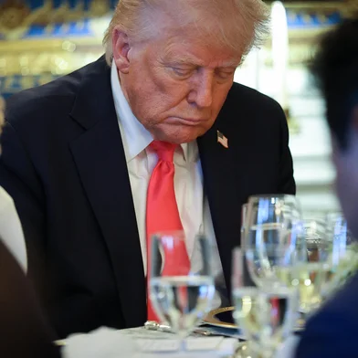 WASHINGTON, DC - APRIL 16: U.S. President Donald Trump bows his head in prayer after delivering remarks during an Easter Prayer Service and Dinner in the Blue Room of the White House on April 16, 2025 in Washington, DC. Christians across the globe will celebrate Easter on Sunday, April 20.   Win McNamee/Getty Images/AFP (Photo by WIN MCNAMEE / GETTY IMAGES NORTH AMERICA / Getty Images via AFP)<!-- NICAID(16018868) -->