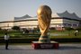 FBL-WC-2022-STADIUM-AL-BAYTA man takes a picture of a FIFA World Cup trophy replica in front of the Al-Bayt Stadium in al-Khor on November 10, 2022, ahead of the Qatar 2022 FIFA World Cup football tournament. Taça da Copa do MundoKirill KUDRYAVTSEV / AFP