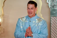 Hollywood actor John Cena gestures as he arrives for the wedding ceremony of billionaire tycoon and Chairman of Reliance Industries Mukesh Ambani's son Anant Ambani and Radhika Merchant in Mumbai on July 12, 2024. Socialite sisters Kim and Khloe Kardashian were among the global celebrities spotted in India on July 12 to attend a lavish three-day wedding ceremony staged by Asia's richest man Mukesh Ambani. (Photo by Punit PARANJPE / AFP)<!-- NICAID(15813586) -->