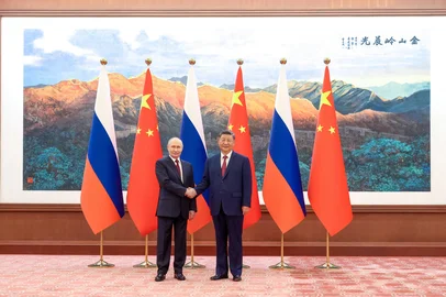 In this pool photograph distributed by the Russian state agency Sputnik, Russia's President Vladimir Putin (L) shakes hands with China's President Xi Jinping during a meeting in Beijing on May 20, 2026. (Photo by Maxim Stulov / POOL / AFP)<!-- NICAID(16288904) -->