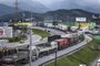 Supporters of President Jair Bolsonaro, mainly truck drivers, block the BR-101 highway in Palhoca, in the metropolitan region of Florianopolis, Santa Catarina State, Brazil, on October 31, 2022, as an apparent protest over Bolsonaro's defeat in the presidential run-off election. - The transition period got off to a tense start as truckers and demonstrators blocked several highways across Brazil on Monday in an apparent protest over the electoral defeat of Bolsonaro to leftist Luiz Inacio Lula da Silva, burning tyres and parking vehicles in the middle of the road to halt traffic. (Photo by Anderson Coelho / AFP)<!-- NICAID(15252019) -->