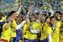 Players of Boca Juniors celebrate with the trophy after winning the Argentine Professional Football League tournament, after tying 2-2 with Independiente at La Bombonera stadium in Buenos Aires, on October 23, 2022. (Photo by Alejandro PAGNI / AFP)<!-- NICAID(15244322) -->