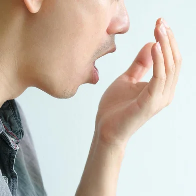 Oral health Men use hands to check for bad breath and breathe.Indexador:                                 Fonte: 309512017<!-- NICAID(15775134) -->