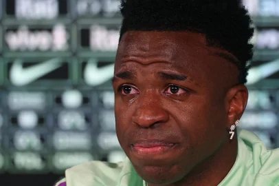 Brazil's forward Vinicius Junior cries as he gives a press conference on the eve of the international friendly football match between Spain and Brazil at the Ciudad Real Madrid training ground in Valdebebas, outskirts of Madrid, on March 25, 2024. Spain arranged a friendly against Brazil at the Santiago Bernabeu under the slogan "One Skin" to help combat racism. (Photo by Pierre-Philippe MARCOU / AFP)<!-- NICAID(15715249) -->