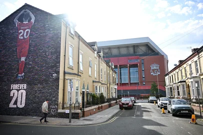 A new mural is seen on the end of a street of terraced houses, dedicated to the Portugese footballer who died in a car crash last month, created by artist Murwalls adjacent to Anfield stadium in Liverpool, north west England, on August 11, 2025. (Photo by Paul ELLIS / AFP) / RESTRICTED TO EDITORIAL USE - MANDATORY MENTION OF THE ARTIST UPON PUBLICATION - TO ILLUSTRATE THE EVENT AS SPECIFIED IN THE CAPTION<!-- NICAID(16102463) -->
