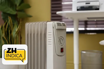 Modern portable electric heater in room, closeup <!-- NICAID(16317175) -->
