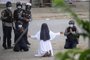 This handout photo taken on March 8, 2021 and released on March 9 by the Myitkyina News Journal shows a nun pleading with police not to harm protesters in Myitkyina in Myanmar's Kachin state, amid a crackdown on demonstrations against the military coup. (Photo by Handout / Myitkyina News Journal / AFP) / RESTRICTED TO EDITORIAL USE - MANDATORY CREDIT "AFP PHOTO / Myitkyina News Journal " - NO MARKETING - NO ADVERTISING CAMPAIGNS - DISTRIBUTED AS A SERVICE TO CLIENTS<!-- NICAID(14731709) -->