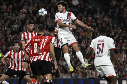 Paris Saint-Germain's Portuguese midfielder #87 Joao Neves jumps for the ball during the UEFA Champions League league phase day 6 football match between Athletic Club Bilbao and Paris Saint-Germain (PSG) at San Mames Stadium in Bilbao on December 10, 2025. (Photo by ANDER GILLENEA / AFP)<!-- NICAID(16184313) -->