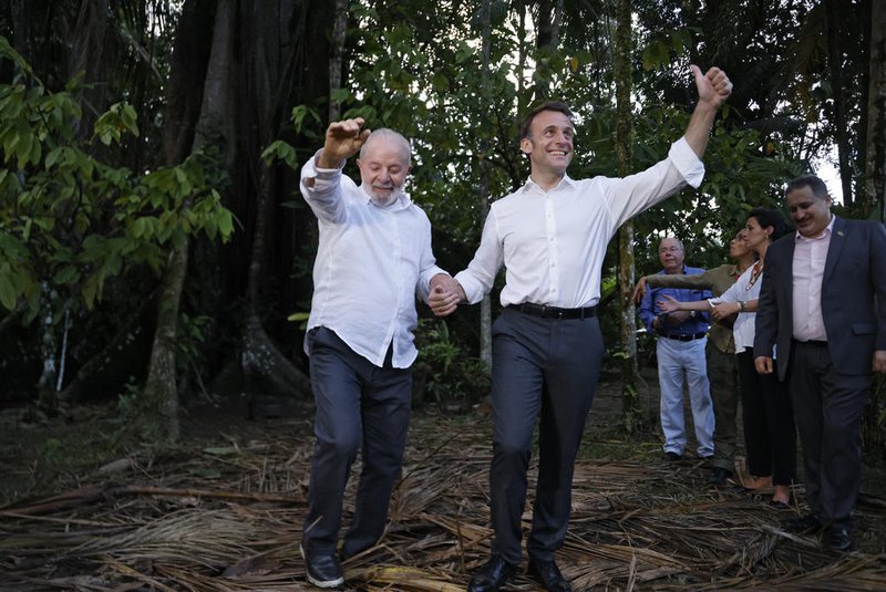 Brazilian President Luiz Inacio Lula Da Silva (L) and French President Emmanuel Macron react on arrival at Combu Island, in front of Belem, state of Para, Brazil, on March 26, 2024. French and Brazilian presidents Emmanuel Macron and Luiz Inacio Lula da Silva launched a program Tuesday aimed at raising up to one billion euros in green investments in the Brazilian and Guyanese Amazon, the French presidency announced. (Photo by Ludovic MARIN / AFP)<!-- NICAID(15717832) -->