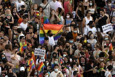 People take part in a Pride march in Madrid on July 3, 2021. - The slogan of 2021's march is  Human rights are not negotiated, they are legislated: Trans Law Now. The march, which have a limited capacity, without any floats and demanding equal rights for the LGBTQ community. (Photo by OSCAR DEL POZO / AFP)<!-- NICAID(14826740) -->
