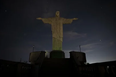 The Christ the Redeemer statue is seen without illumination to condemn racist acts against Brazilian footballer Vinicius Junior in Rio de Janeiro, Brazil, on May 22, 2023. The world-famous landmark had its illumination turned off for one hour in solidarity with Real Madrid's player Vinicius Junior, who was the target of persistent racist abuse during his teams 1-0 defeat to Valencia at the Mestalla Stadium in Spains La Liga on May 21, 2023. The act was described "as a symbol of the collective struggle against racism and in solidarity with the player and all those who suffer prejudice around the world." (Photo by CARLOS FABAL / AFP)<!-- NICAID(15435581) -->