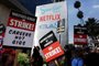 LOS ANGELES, CALIFORNIA - SEPTEMBER 22: Striking WGA (Writers Guild of America) members picket with striking SAG-AFTRA members outside Netflix studios on September 22, 2023 in Los Angeles, California. The Writers Guild of America and Alliance of Motion Picture and Television Producers (AMPTP) are reportedly meeting for a third straight day today in a new round of contract talks in the nearly five-months long writers strike.   Mario Tama/Getty Images/AFP (Photo by MARIO TAMA / GETTY IMAGES NORTH AMERICA / Getty Images via AFP)<!-- NICAID(15550126) -->