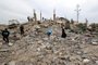 Palestinians check the rubble following Israeli bombardment in Rafah in the southern Gaza Strip on December 21, 2023, amid continuing battles between Israel and the militant group Hamas. (Photo by Mohammed ABED / AFP)<!-- NICAID(15631658) -->