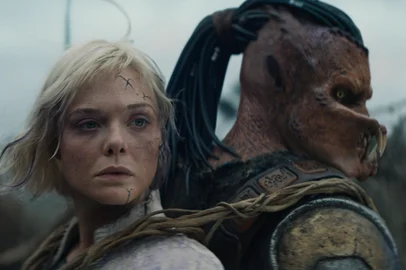 (L-R) Thia (Elle Fanning) and Dek (Dimitrius Schuster-Koloamatangi) in 20th Century Studios' PREDATOR: BADLANDS film. Photo courtesy of 20th Century Studios. Â© 2025 20th Century Studios. All Rights Reserved.Terras Selvagens (2025), filme de Dan Trachtenberg<!-- NICAID(16162460) -->