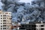 EDITORS NOTE: Graphic content / A plume of smoke rises above buildings in Gaza City on October 7, 2023 during an Israeli air strike. At least 70 people were reported killed in Israel, while Gaza authorities released a death toll of 198 in the bloodiest escalation in the wider conflict since May 2021, with hundreds more wounded on both sides. (Photo by MAHMUD HAMS / AFP)<!-- NICAID(15563079) -->