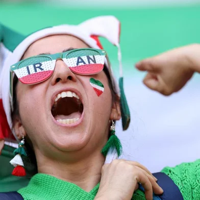 Iran supporter cheers for her team as she attends the Qatar 2022 World Cup Group B football match between Wales and Iran at the Ahmad Bin Ali Stadium in Al-Rayyan, west of Doha on November 25, 2022. (Photo by FADEL SENNA / AFP)<!-- NICAID(15277172) -->